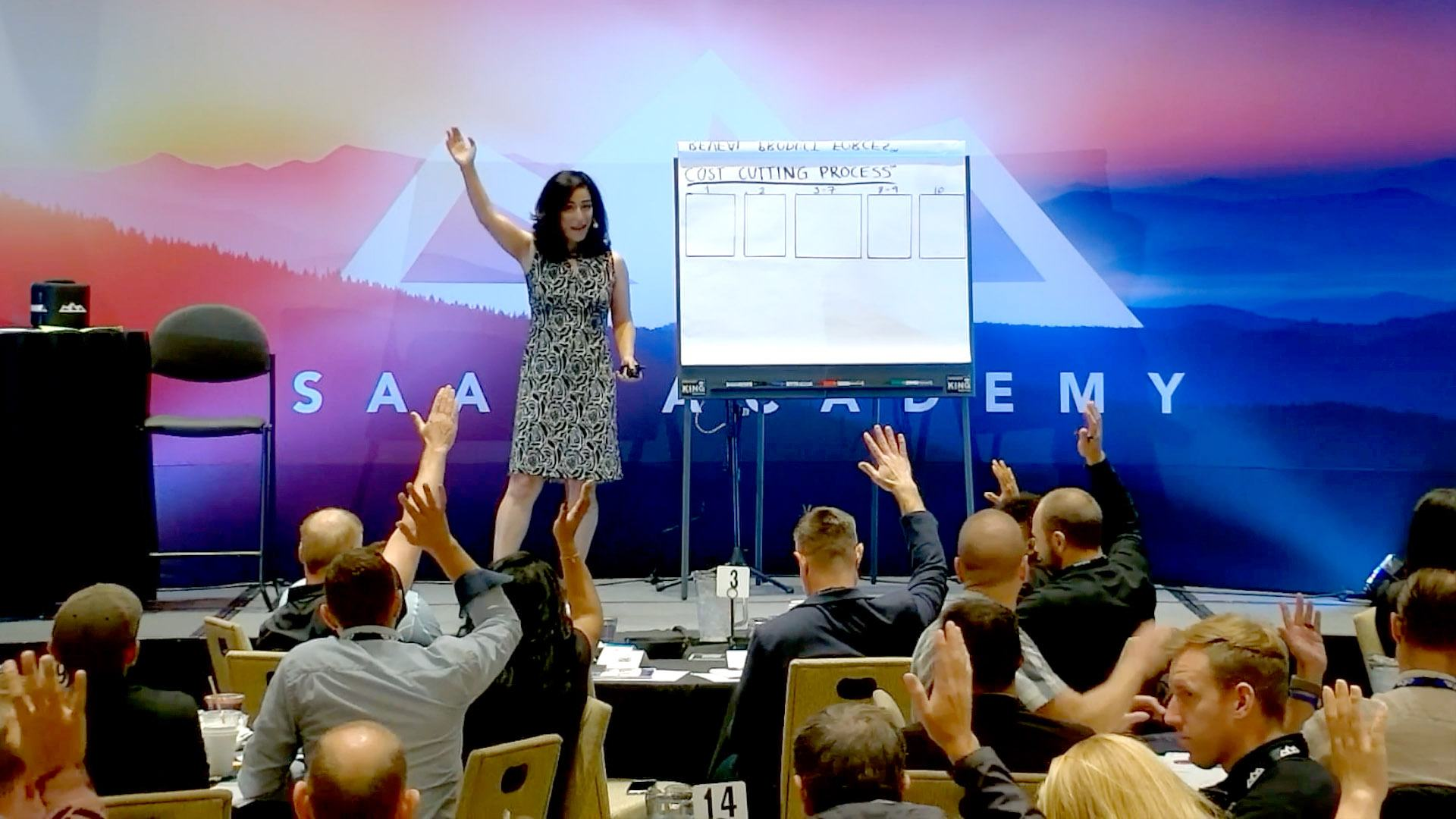 Nelly on stage at SaaS Academy, engaging the audience